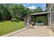 Backyard boasts covered patio with outdoor dining near a green lawn at 425 Eldridge Drive Dr, Suwanee, GA 30024