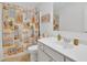 This bathroom offers a vanity with a sink and a shower with a beach-themed curtain at 425 Eldridge Drive Dr, Suwanee, GA 30024