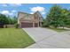 Charming two-story home with stone accents, a well-manicured lawn, and a spacious two car garage at 425 Eldridge Drive Dr, Suwanee, GA 30024