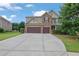 Charming two-story home with stone accents, a well-manicured lawn, and a spacious two car garage at 425 Eldridge Drive Dr, Suwanee, GA 30024