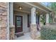 Inviting front porch with stacked stone accents and classic exterior lighting, perfect for relaxing at 425 Eldridge Drive Dr, Suwanee, GA 30024