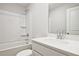 Clean bathroom with single vanity, tub shower combo with white ceramic tile surround at 689 Sunstone Ln, Lawrenceville, GA 30043