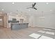 Open-concept living space featuring a kitchen island, stainless appliances, and hardwood flooring for a modern aesthetic at 689 Sunstone Ln, Lawrenceville, GA 30043