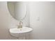 Contemporary bathroom with a sleek, pedestal sink and modern mirror at 693 Sunstone Ln, Lawrenceville, GA 30043