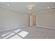 Bright bedroom features neutral walls, plush carpeting, and recessed lighting at 693 Sunstone Ln, Lawrenceville, GA 30043