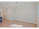 Bright dining room with elegant chandelier and wood-look flooring at 693 Sunstone Ln, Lawrenceville, GA 30043