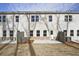 Rear view of the home showcasing a well-maintained yard, concrete patio, and neutral-toned siding with ample windows at 693 Sunstone Ln, Lawrenceville, GA 30043