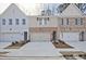 Charming townhomes showcasing brick and siding exteriors, each with a one-car garage at 693 Sunstone Ln, Lawrenceville, GA 30043