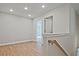 Bright upstairs hallway with access to multiple rooms and wood-look floors at 693 Sunstone Ln, Lawrenceville, GA 30043