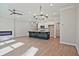 Open living room with fireplace, kitchen island, and wood floors at 693 Sunstone Ln, Lawrenceville, GA 30043