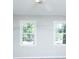 Bright bedroom with two windows providing ample natural light and a ceiling fan at 1391 Warrenton Hunt, Lawrenceville, GA 30043