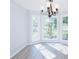 Bright dining room with large windows, elegant chandelier, and new floors at 1391 Warrenton Hunt, Lawrenceville, GA 30043