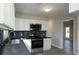 Modern kitchen featuring stainless steel appliances, designer backsplash, and lots of cabinet space at 1391 Warrenton Hunt, Lawrenceville, GA 30043