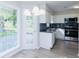 Eat-in kitchen with white cabinets, stainless appliances, and a large window for natural light at 1391 Warrenton Hunt, Lawrenceville, GA 30043
