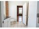 Bright bathroom features exposed brick, a modern vanity, and tiled floors that lead to the tiled shower at 1596 Cleveland Ave # 301, East Point, GA 30344