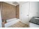 Well-lit bathroom with a tiled shower-tub, granite countertop, and tiled floors at 1596 Cleveland Ave # 301, East Point, GA 30344