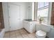 Bathroom boasts natural light, with a tiled floor, modern vanity, and toilet next to a window with a view at 1596 Cleveland Ave # 301, East Point, GA 30344