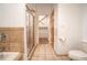 Bright bathroom features a tiled shower, tile floors, and a peek into a walk-in closet for ample storage at 1596 Cleveland Ave # 301, East Point, GA 30344