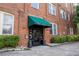 Charming brick building entrance with green awnings at The Lofts of East Point at 1596 Cleveland Ave # 301, East Point, GA 30344