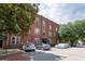Brick multi-story building with green awnings, street parking, and nearby trees at 1596 Cleveland Ave # 301, East Point, GA 30344