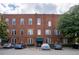 Charming red brick multi-story building, 'The Lofts of East Point', with ample parking on a partly cloudy day at 1596 Cleveland Ave # 301, East Point, GA 30344
