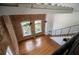 An aerial view showcasing the living room with hardwood floors, brick wall and staircase at 1596 Cleveland Ave # 301, East Point, GA 30344