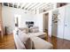 Bright and airy living room with modern decor, hardwood floors and view into study at 1596 Cleveland Ave # 301, East Point, GA 30344