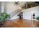 Spacious living room with hardwood floors, staircase to the loft, and open concept kitchen view at 1596 Cleveland Ave # 301, East Point, GA 30344