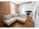 Comfortable living room featuring hardwood floors, exposed brick wall, and bright natural lighting at 1596 Cleveland Ave # 301, East Point, GA 30344