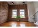 Spacious living room with exposed brick walls, hardwood floors, and lots of natural light at 1596 Cleveland Ave # 301, East Point, GA 30344
