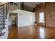 Spacious living room with hardwood floors, exposed brick wall and staircase to the loft at 1596 Cleveland Ave # 301, East Point, GA 30344