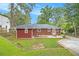 The backyard shows the brick home, landscaping, and a large yard at 2057 Cambridge Ave, Atlanta, GA 30337