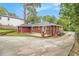 A view of the backyard with lush landscaping and a patio outside the brick home at 2057 Cambridge Ave, Atlanta, GA 30337