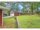An expansive backyard with an eye-level view of the two-car garage with landscaping at 2057 Cambridge Ave, Atlanta, GA 30337