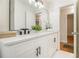 Bathroom featuring a white vanity, modern fixtures, and a view into the hallway at 2057 Cambridge Ave, Atlanta, GA 30337