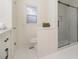 Contemporary bathroom showcases white cabinets, tiled floors, toilet, and a glass shower at 2057 Cambridge Ave, Atlanta, GA 30337
