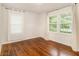 Bedroom featuring hardwood floors, bright windows, and white walls at 2057 Cambridge Ave, Atlanta, GA 30337