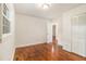 Bedroom features wood floors, a double closet, and a window offering natural light at 2057 Cambridge Ave, Atlanta, GA 30337