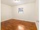 A simple bedroom with hardwood floors, a window, and neutral-colored walls at 2057 Cambridge Ave, Atlanta, GA 30337