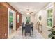 Elegant dining room with brick accent wall, modern lighting, and seating for six guests at 2057 Cambridge Ave, Atlanta, GA 30337