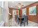 This dining room features brick walls, a modern rug, and a view into the kitchen at 2057 Cambridge Ave, Atlanta, GA 30337