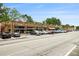 Charming brick building with a variety of businesses, street parking, and mature trees lining the street at 2057 Cambridge Ave, Atlanta, GA 30337