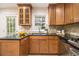 Stylish kitchen featuring granite countertops, wooden cabinets, and stainless steel dishwasher at 2057 Cambridge Ave, Atlanta, GA 30337