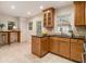 Bright kitchen with granite counters, tile floors, wooden cabinets, and stainless steel dishwasher at 2057 Cambridge Ave, Atlanta, GA 30337