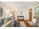 Cozy living room with hardwood floors, a decorative fireplace, and ample natural light at 2057 Cambridge Ave, Atlanta, GA 30337