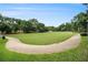 Expansive green park area with walking path lined by trees and benches at 2057 Cambridge Ave, Atlanta, GA 30337