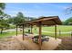 Outdoor picnic area with tables and grill overlooking green space and mature trees at 2057 Cambridge Ave, Atlanta, GA 30337