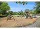 Fun playground featuring swings, slides, and a climbing structure, set in a park-like setting with mature trees at 2057 Cambridge Ave, Atlanta, GA 30337