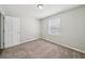 Bedroom featuring carpet, neutral walls, trim, and natural light from a window at 2466 Country Club Dr, Conyers, GA 30013