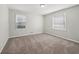 Bedroom with carpet, neutral walls, and natural light from two windows at 2466 Country Club Dr, Conyers, GA 30013